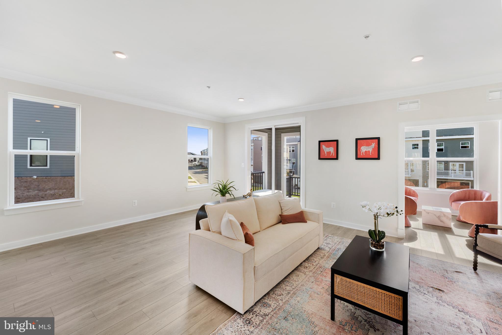 129 Summit Point Boulevard, Unit 11J Bowie, MD 20716 - Photo 21 of 45 a living room with furniture and a wooden floor