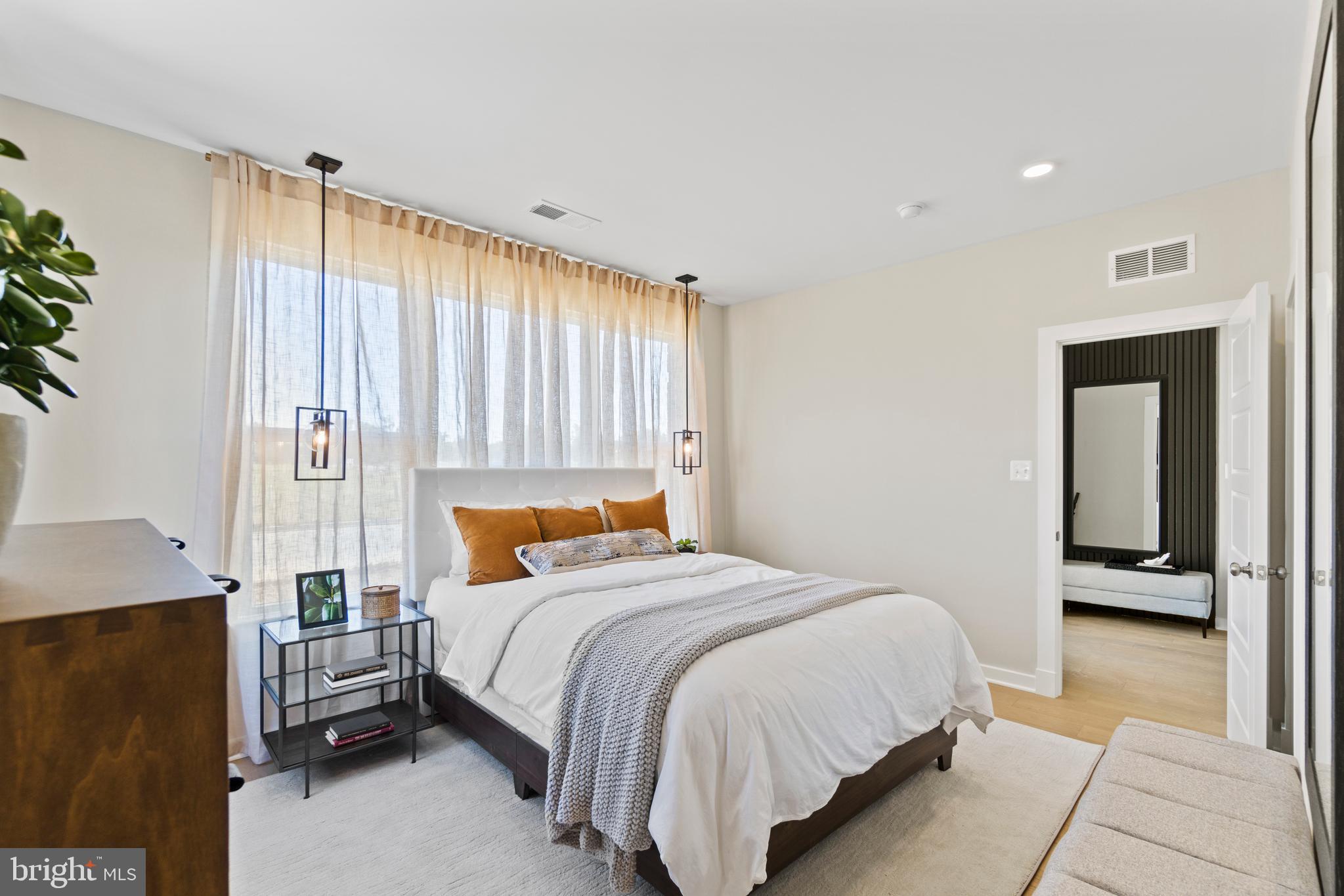 129 Summit Point Boulevard, Unit 11J Bowie, MD 20716 - Photo 23 of 45 a bedroom with a bed and a window