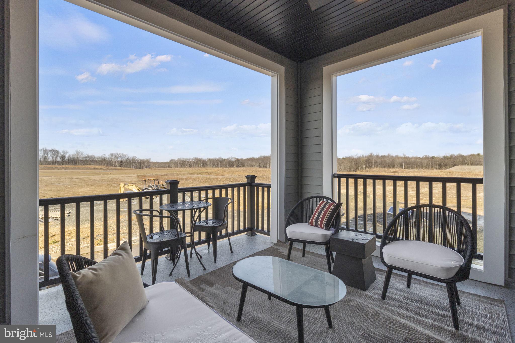 129 Summit Point Boulevard, Unit 11J Bowie, MD 20716 - Photo 27 of 45 a balcony with furniture and a potted plant