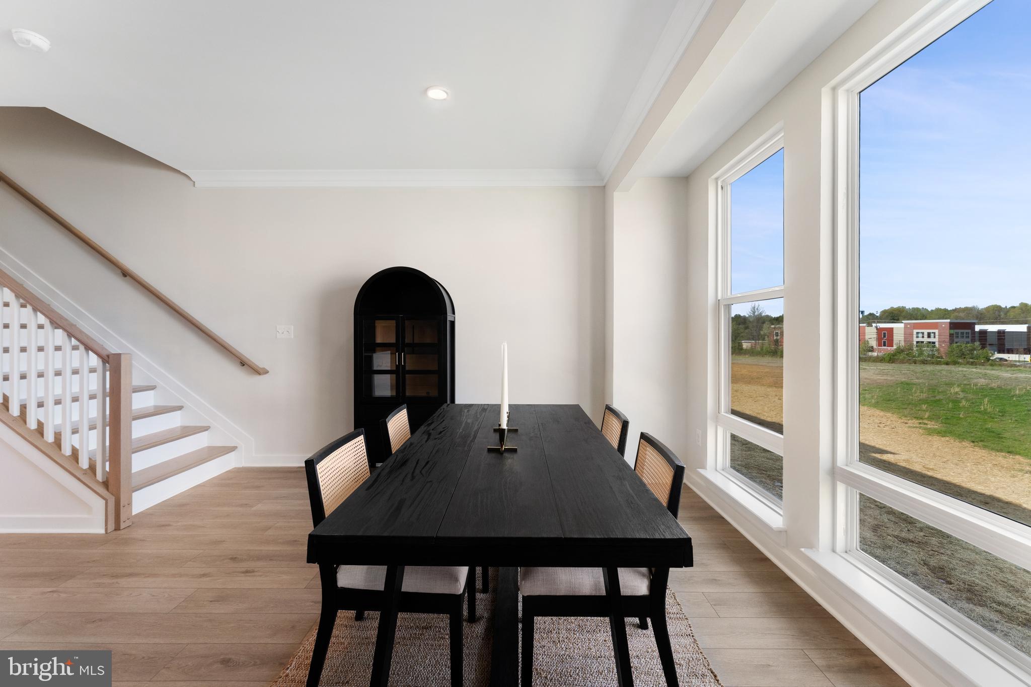 129 Summit Point Boulevard, Unit 11J Bowie, MD 20716 - Photo 28 of 45 a view of a dining room with furniture and wooden floor