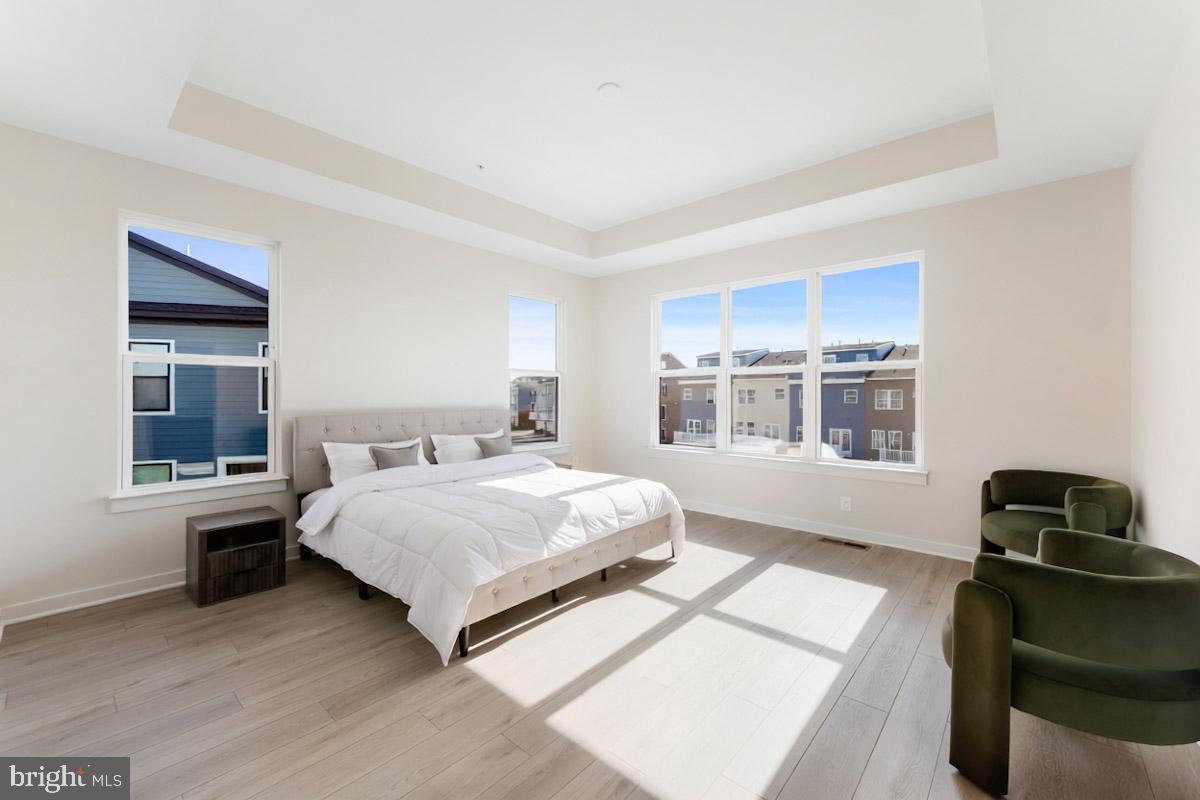 129 Summit Point Boulevard, Unit 11J Bowie, MD 20716 - Photo 29 of 45 a spacious bedroom with a bed and a window