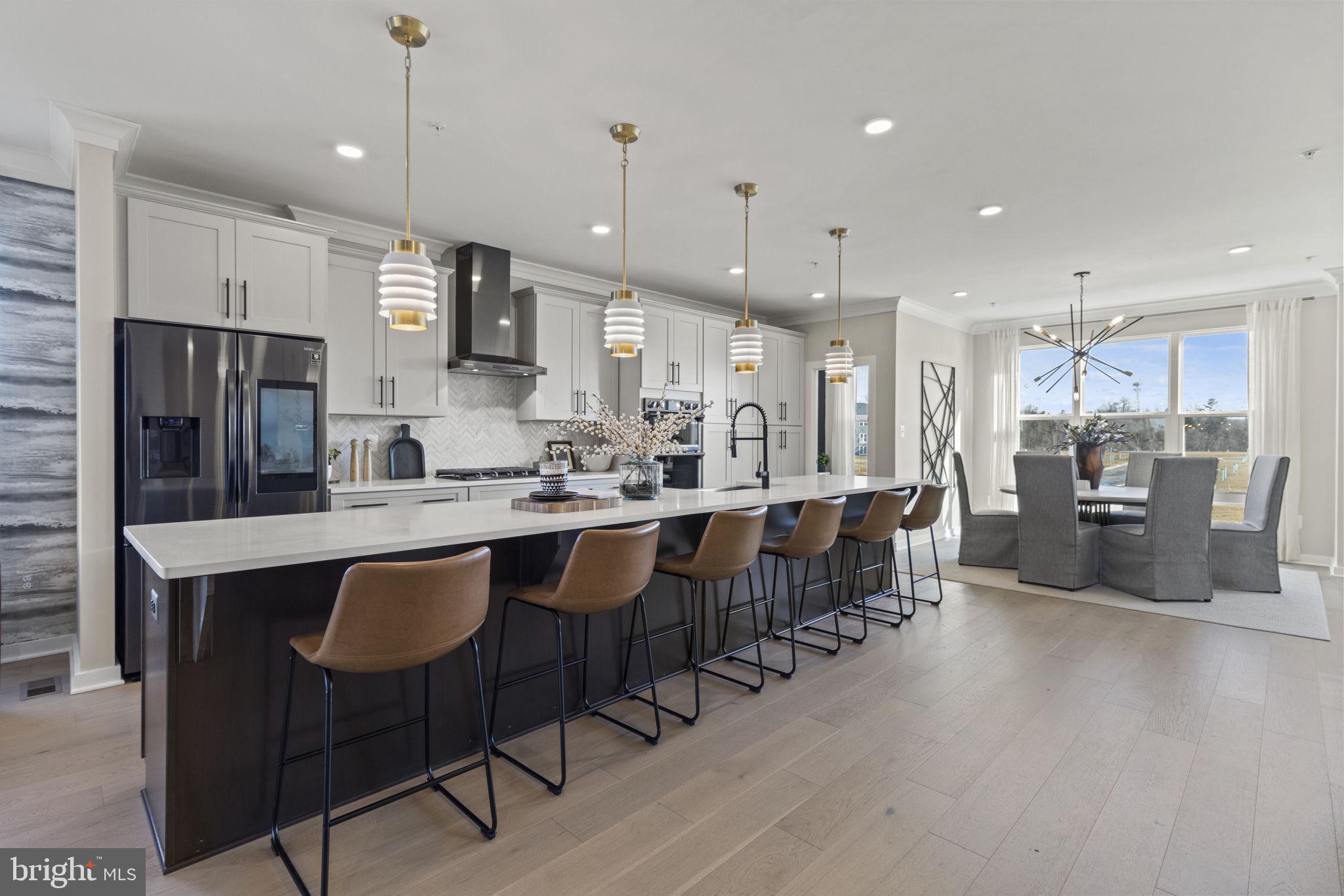 129 Summit Point Boulevard, Unit 11J Bowie, MD 20716 - Photo 3 of 45 a large kitchen with a table and chairs