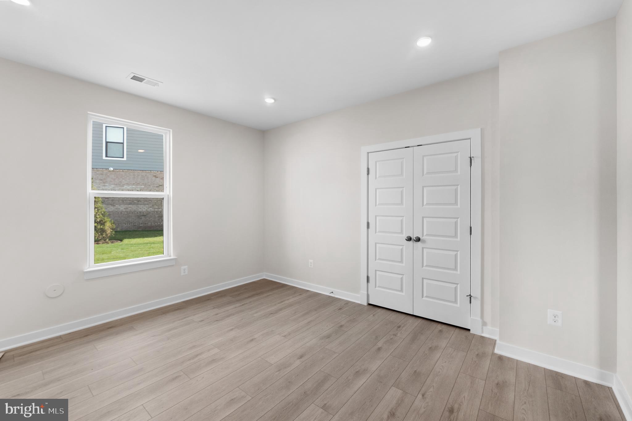 129 Summit Point Boulevard, Unit 11J Bowie, MD 20716 - Photo 35 of 45 an empty room with windows and closet