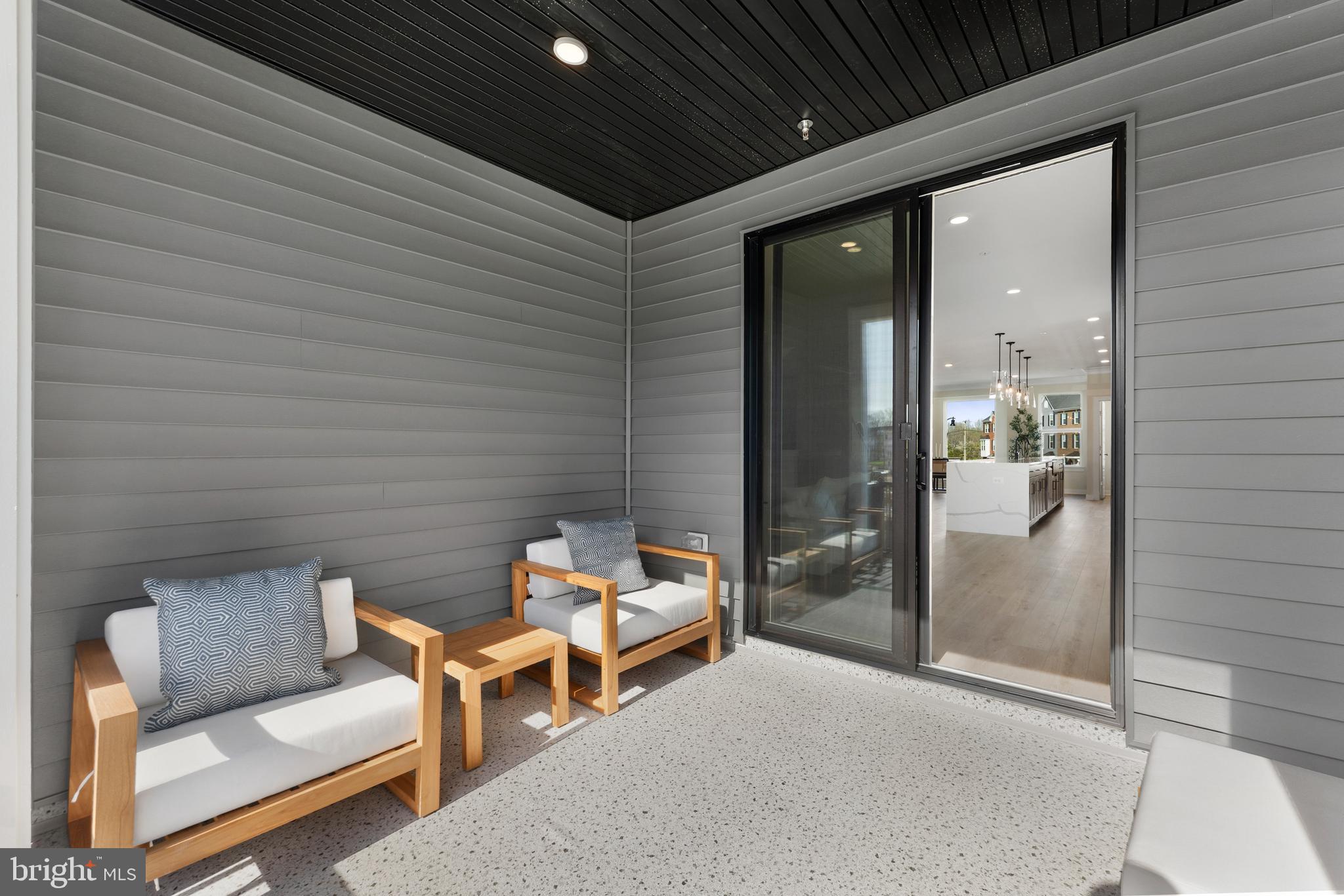 129 Summit Point Boulevard, Unit 11J Bowie, MD 20716 - Photo 42 of 45 a backyard of a house with outdoor seating