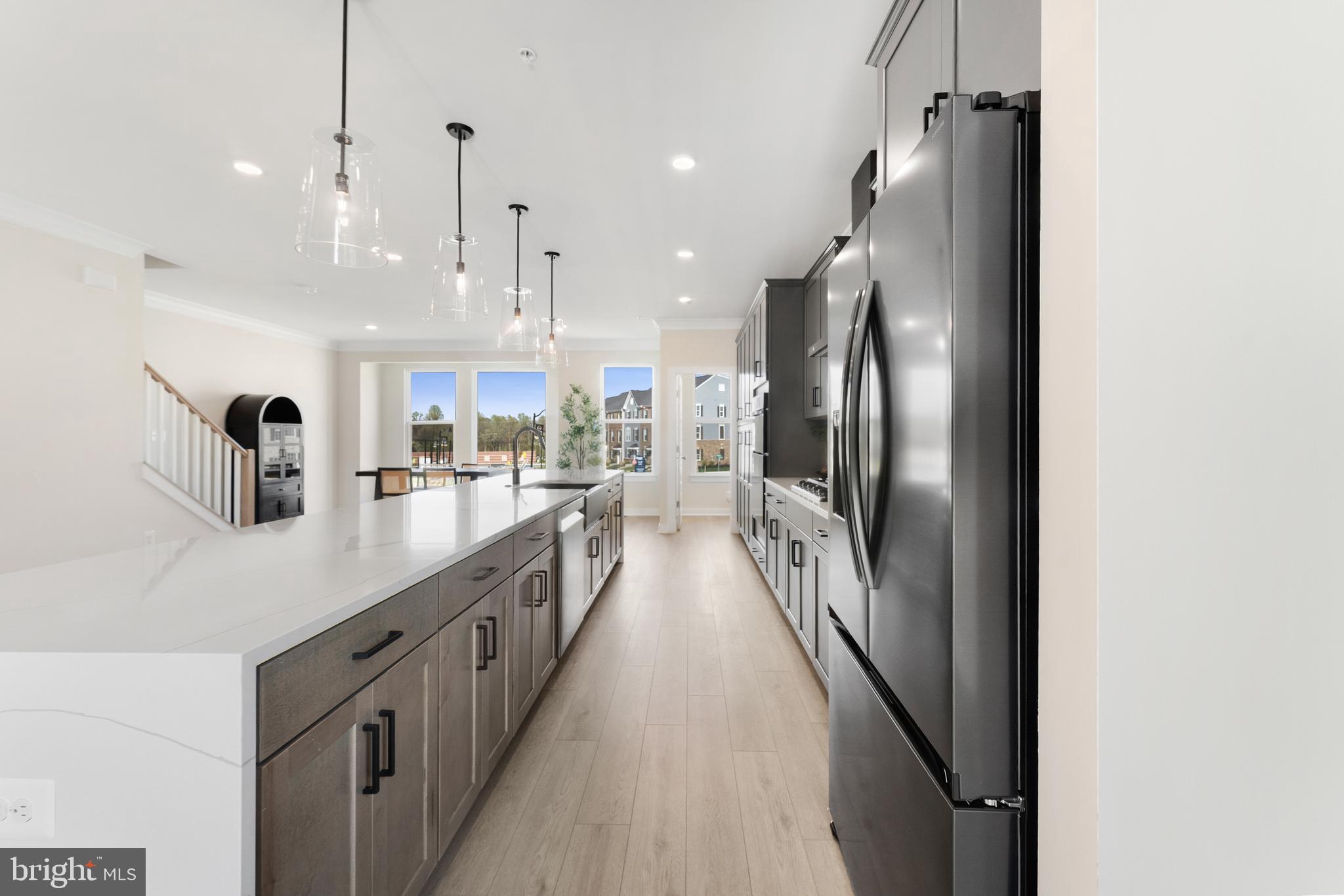129 Summit Point Boulevard, Unit 11J Bowie, MD 20716 - Photo 5 of 45 a kitchen with stainless steel appliances granite countertop a refrigerator a oven a sink and a island