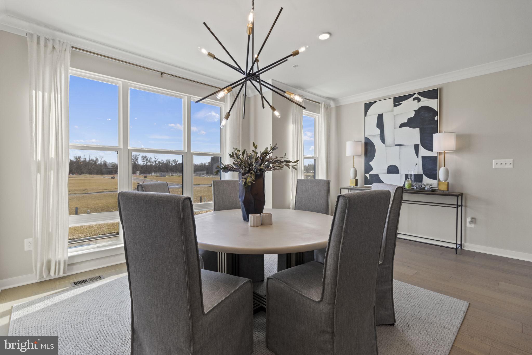 129 Summit Point Boulevard, Unit 11J Bowie, MD 20716 - Photo 8 of 45 a dining room with furniture window and wooden floor