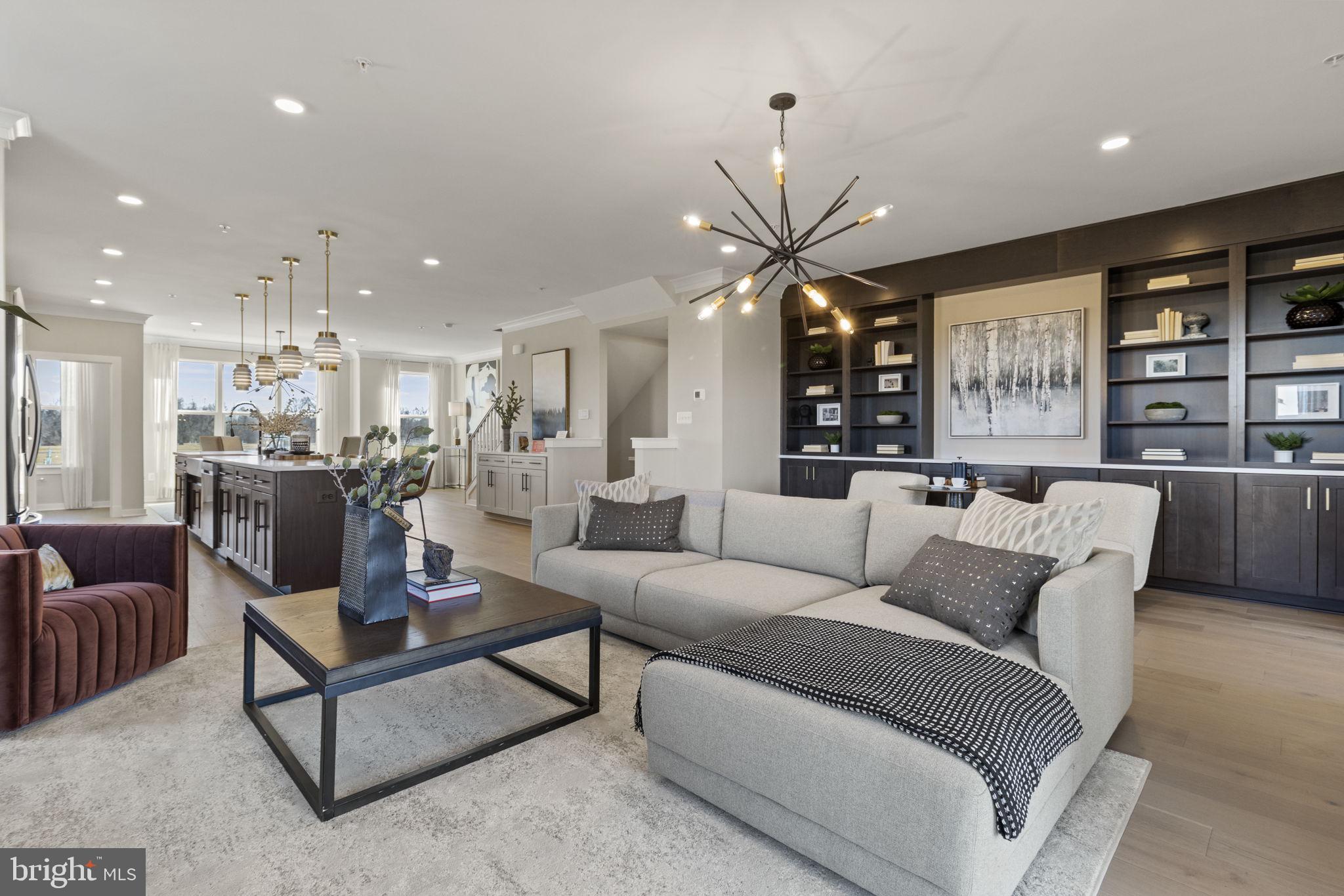129 Summit Point Boulevard, Unit 11J Bowie, MD 20716 - Photo 9 of 45 a living room with furniture kitchen view and a chandelier