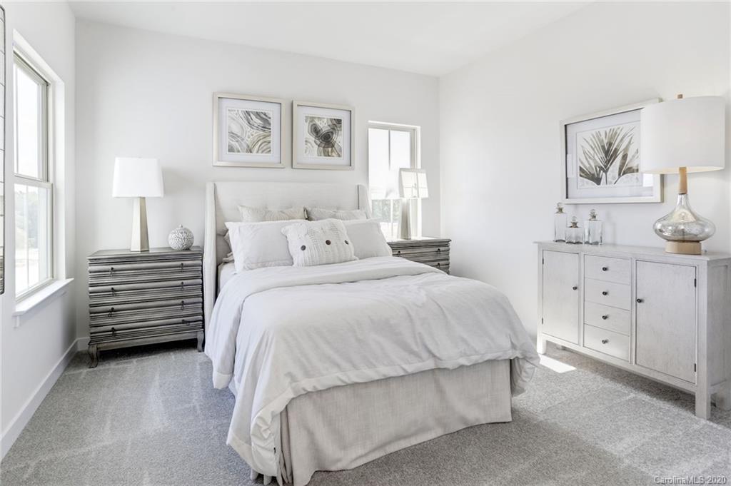 620 Crudent Road, Unit 1004B Tega Cay, SC 29708 - Photo 11 of 12 a bedroom with a bed and a night stand