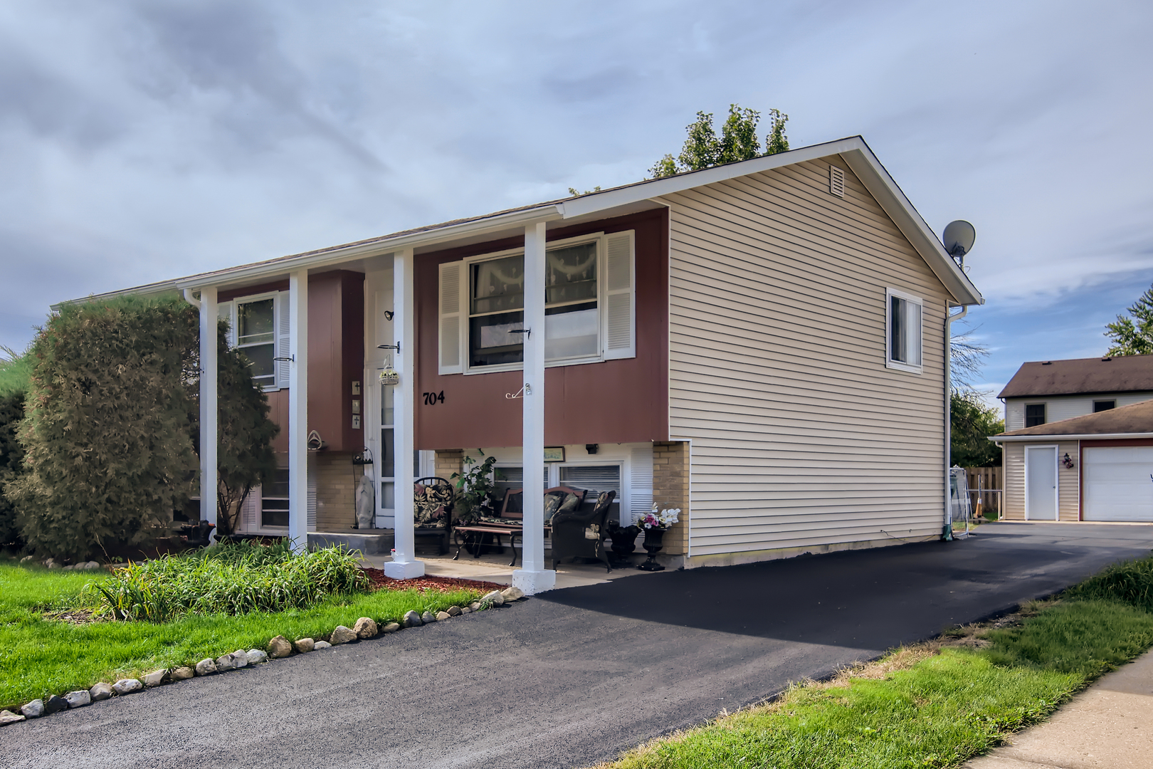 704 Evergreen Court Romeoville, IL 60446 - Photo 1 of 15 a front view of a house with a yard