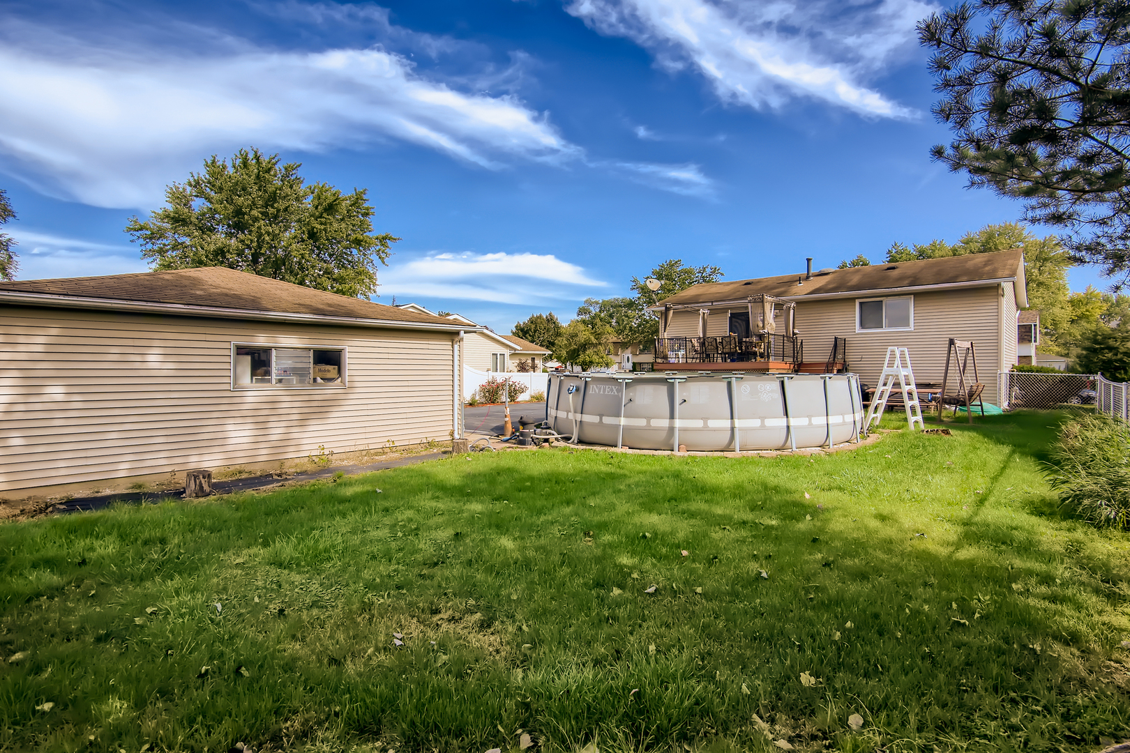 704 Evergreen Court Romeoville, IL 60446 - Photo 12 of 15 a backyard of a house with table and chairs