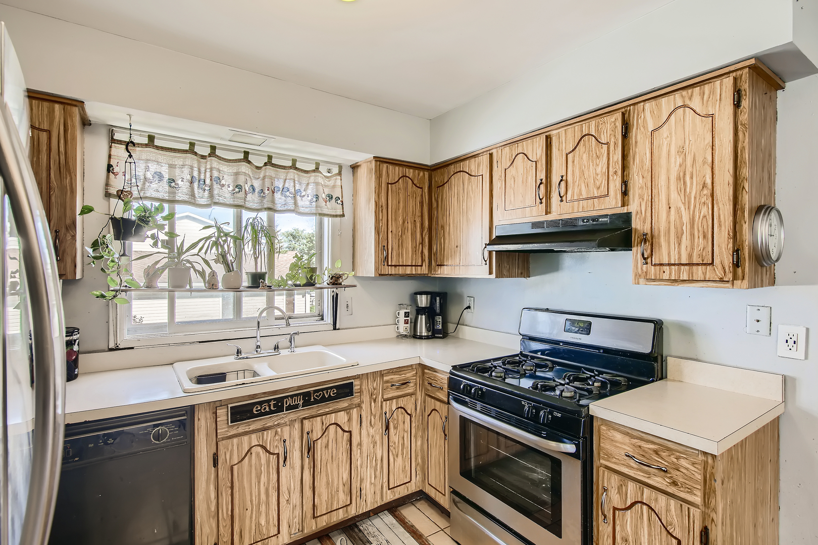 704 Evergreen Court Romeoville, IL 60446 - Photo 5 of 15 a kitchen with stainless steel appliances a sink a stove and cabinets