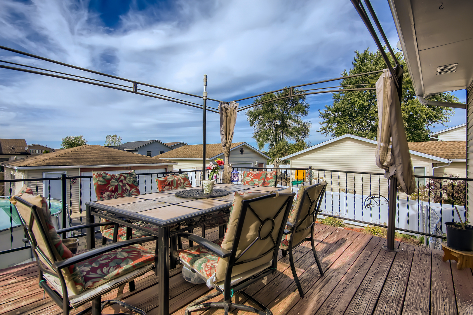 704 Evergreen Court Romeoville, IL 60446 - Photo 10 of 15 a view of a patio with a table chairs and wooden floor