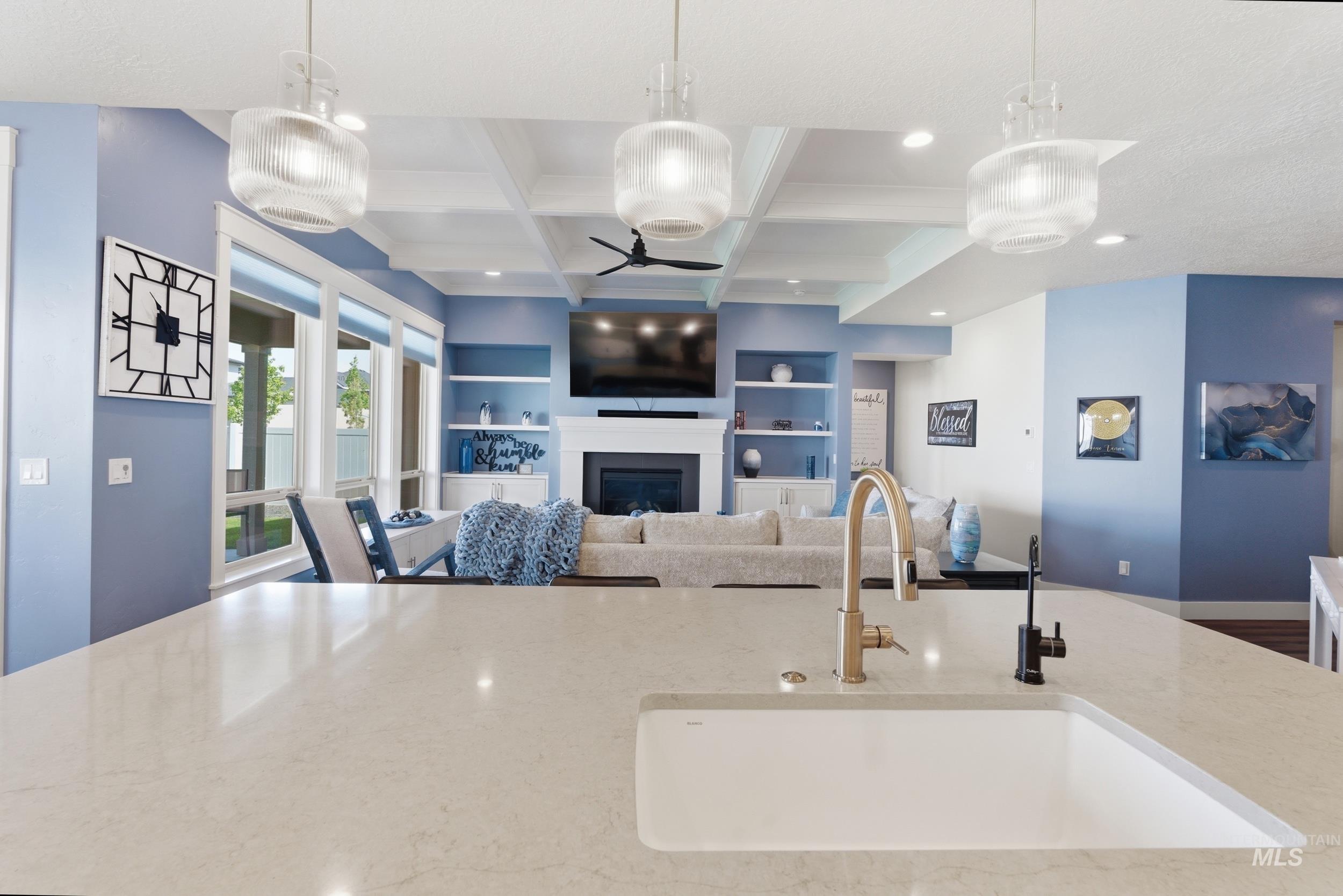 6347 South Utmost Lane Meridian, ID 83642 - Photo 14 of 37 Spacious kitchen island featuring a white undermount sink and a gold-tone faucet