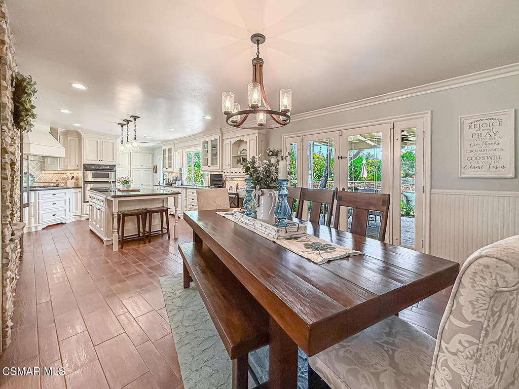 3116 Lori Circle Simi Valley, CA 93063 - Photo 13 of 74 a dining room with wooden floor a chandelier a wooden table and chairs