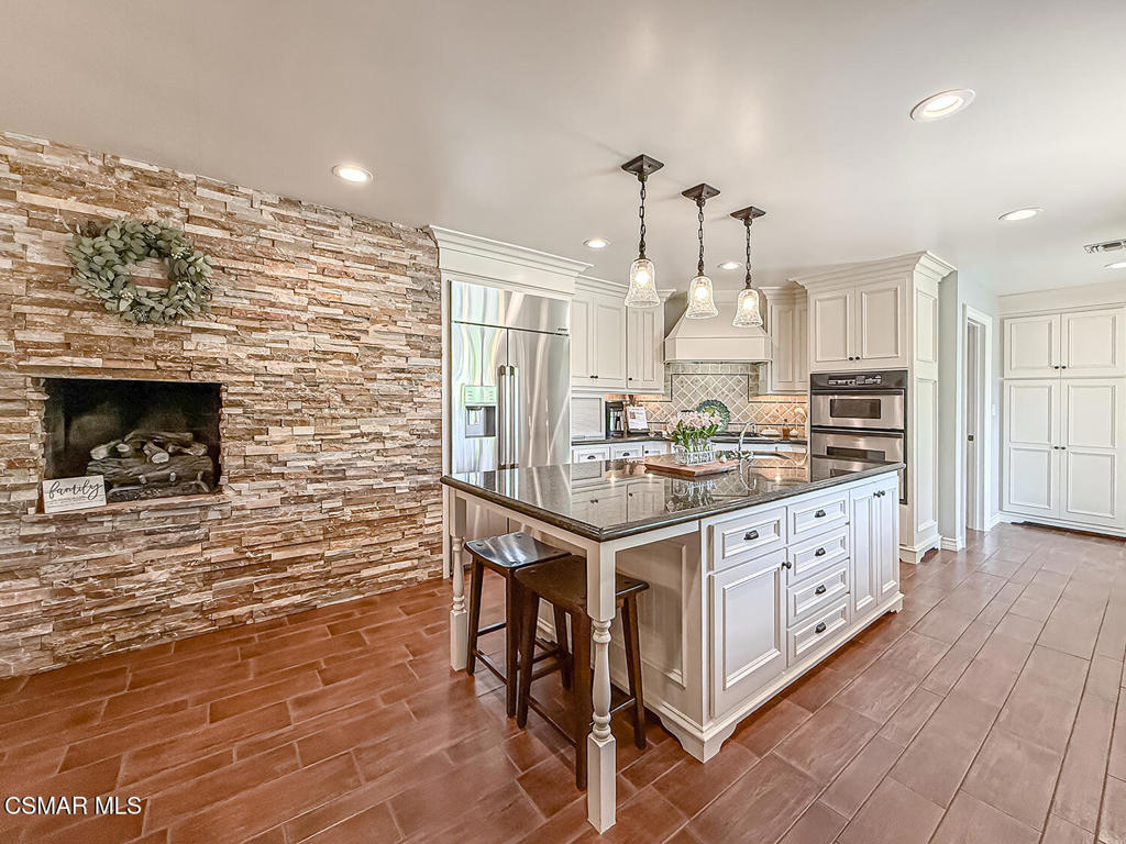 3116 Lori Circle Simi Valley, CA 93063 - Photo 16 of 74 a kitchen with stainless steel appliances kitchen island granite countertop a stove a sink and a refrigerator