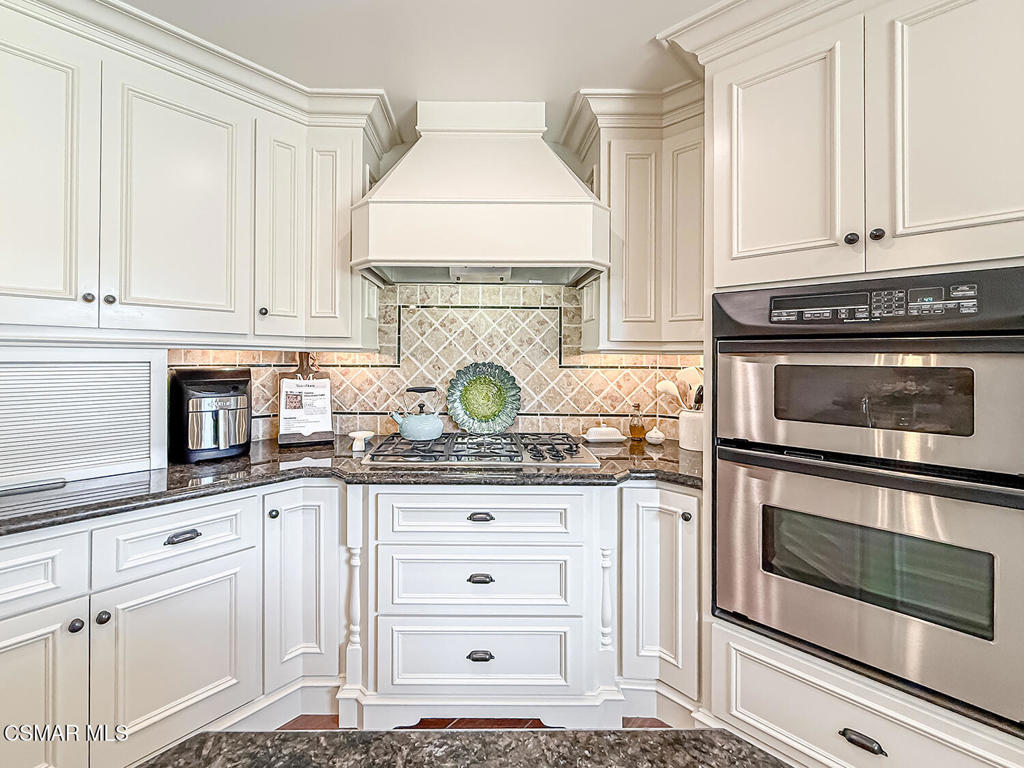 3116 Lori Circle Simi Valley, CA 93063 - Photo 19 of 74 a kitchen with granite countertop white cabinets and appliances