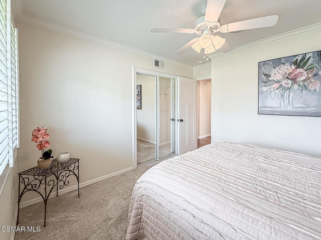 3116 Lori Circle Simi Valley, CA 93063 - Photo 30 of 74 a bedroom with a bed and a chandelier
