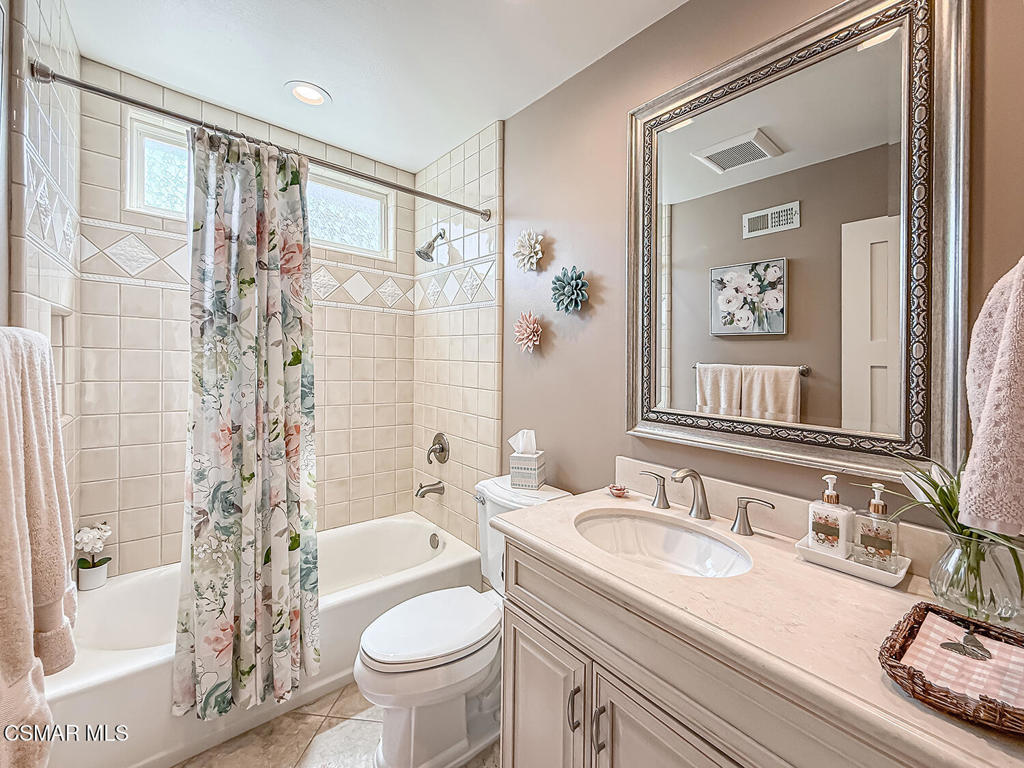 3116 Lori Circle Simi Valley, CA 93063 - Photo 31 of 74 a bathroom with a granite countertop sink toilet a mirror a vanity and shower