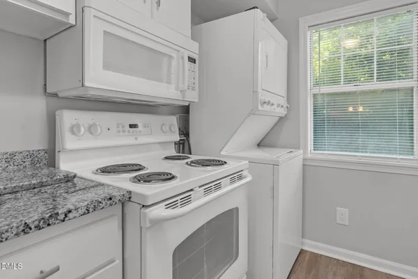a white stove top oven sitting inside of a kitchen