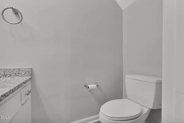 a white toilet sitting next to a white sink