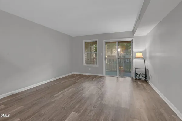 wooden floor in an empty room with a window