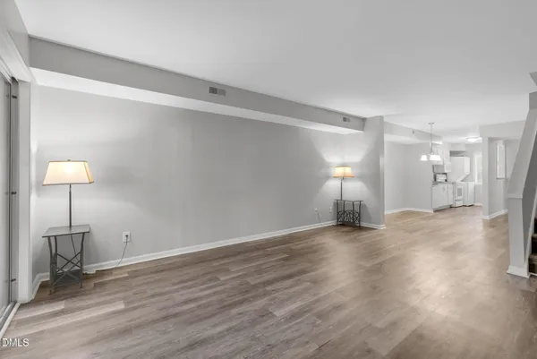 a view of empty room with wooden floor