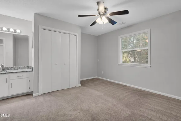 a view of an empty room with a bathroom