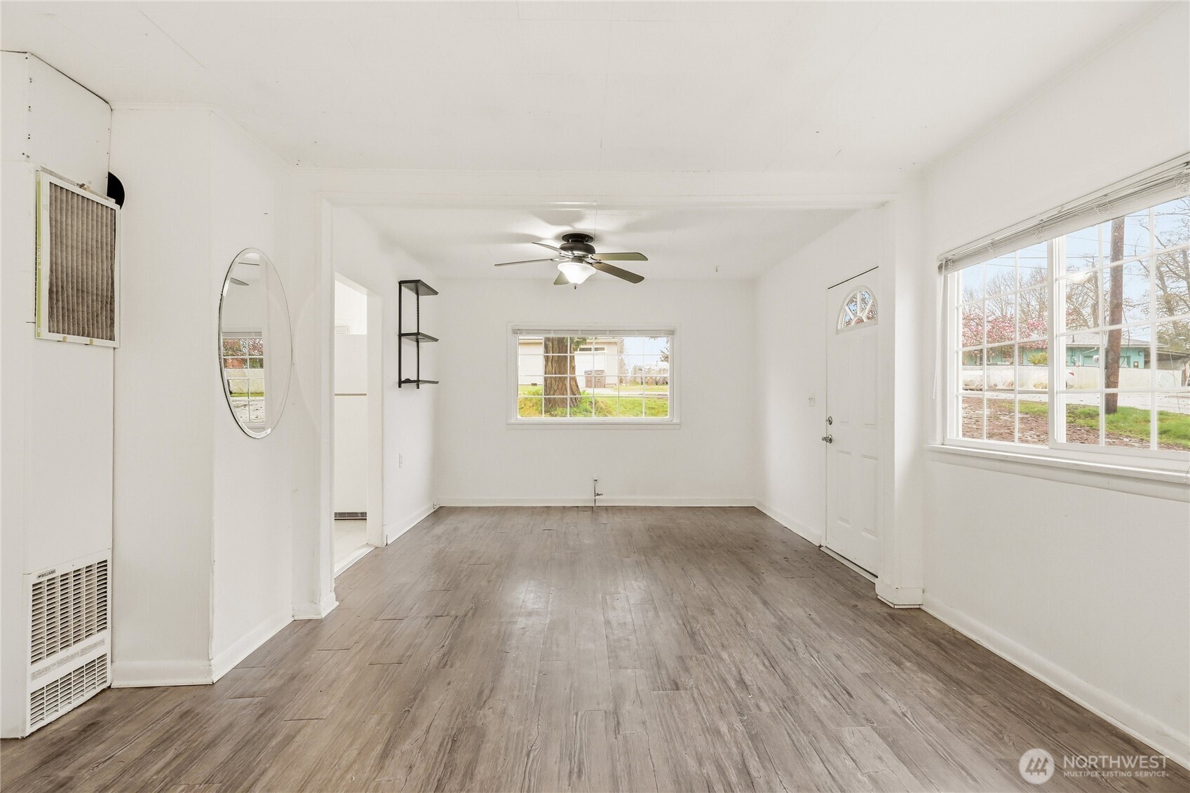 1505 Retsil Road Southeast Port Orchard, WA 98366 - Photo 4 of 19 wooden floor in an empty room with a window