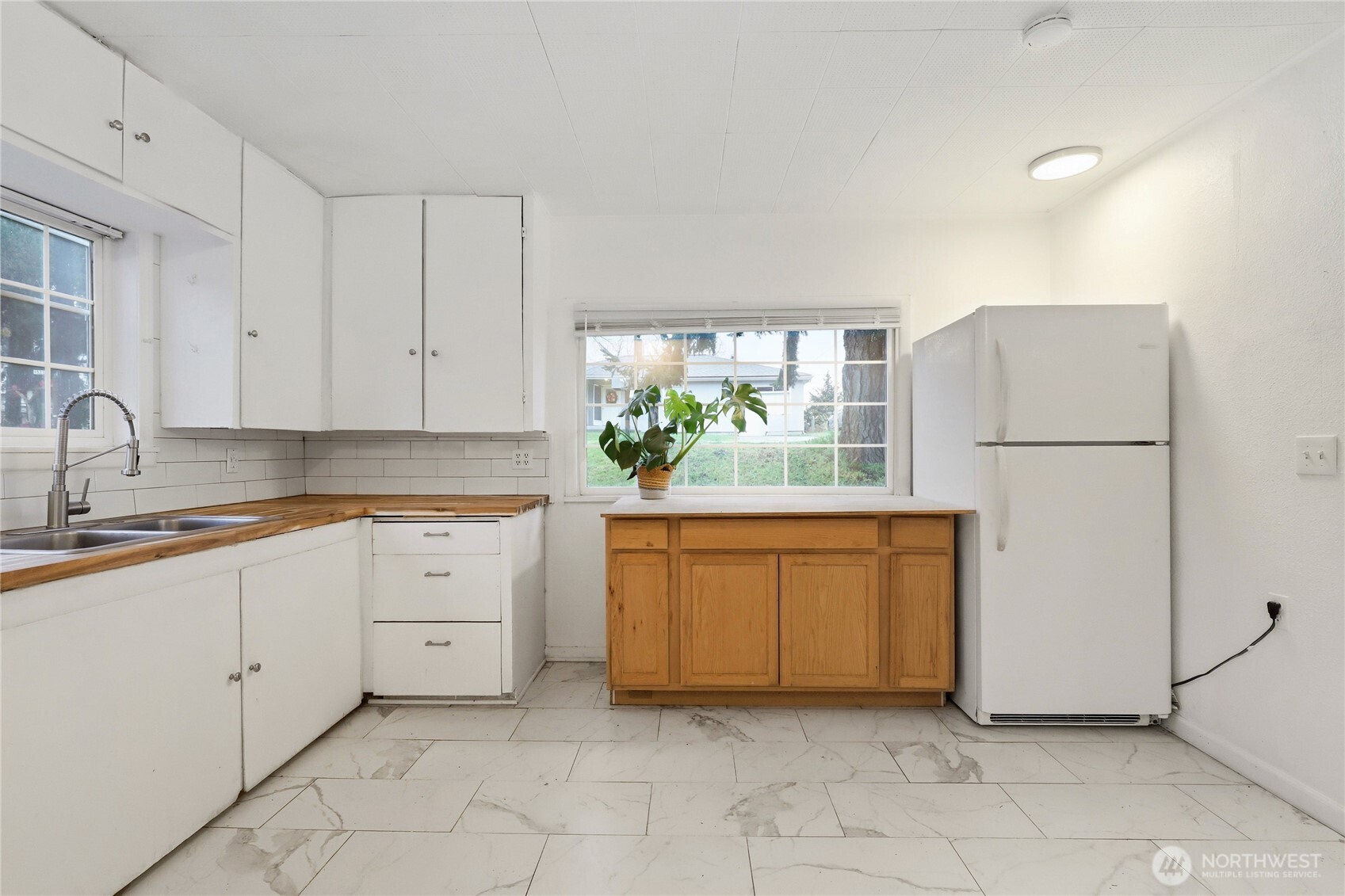 1505 Retsil Road Southeast Port Orchard, WA 98366 - Photo 8 of 19 a kitchen with stainless steel appliances granite countertop white cabinets a refrigerator and a sink