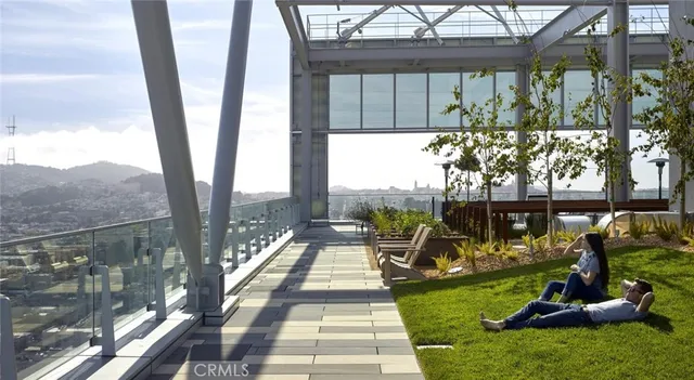 a view of a lobby with furniture and kitchen view