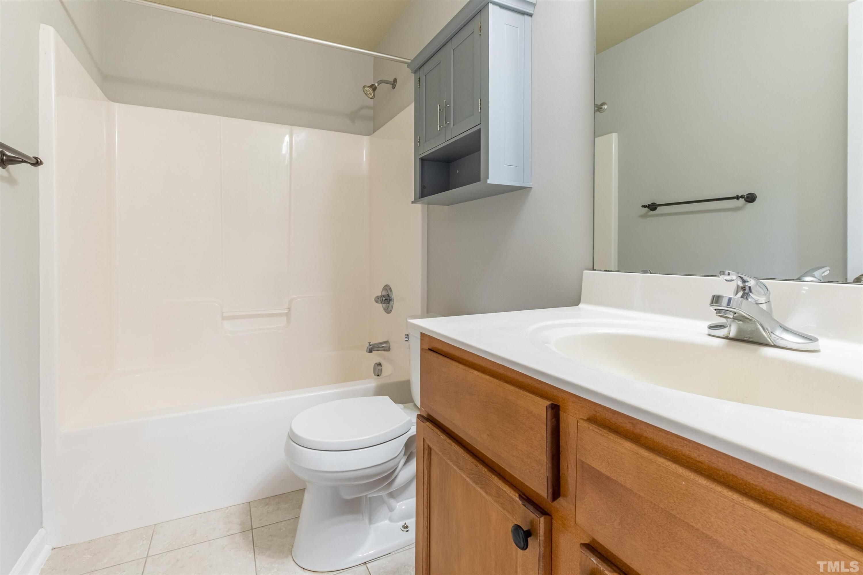 125 Old Grove Lane Apex, NC 27502 - Photo 14 of 30 a bathroom with a sink a toilet and a shower