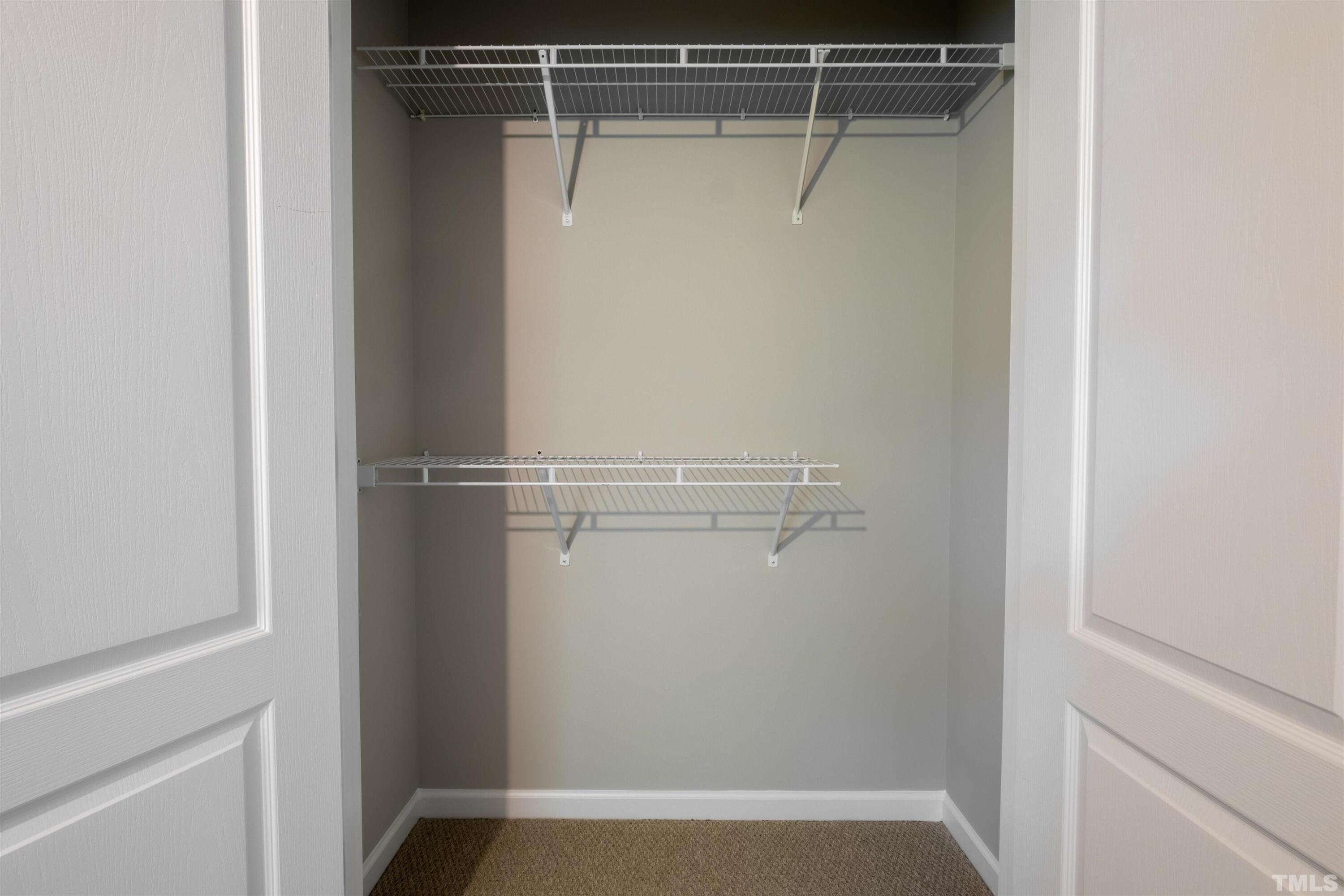 125 Old Grove Lane Apex, NC 27502 - Photo 16 of 30 a view of walk in closet with empty racks