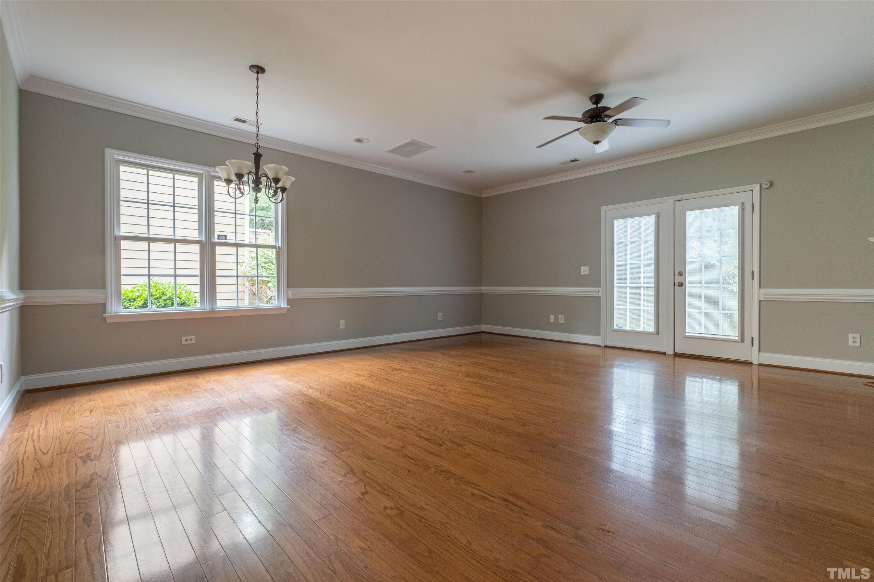 125 Old Grove Lane Apex, NC 27502 - Photo 2 of 30 a view of an empty room with wooden floor and a window