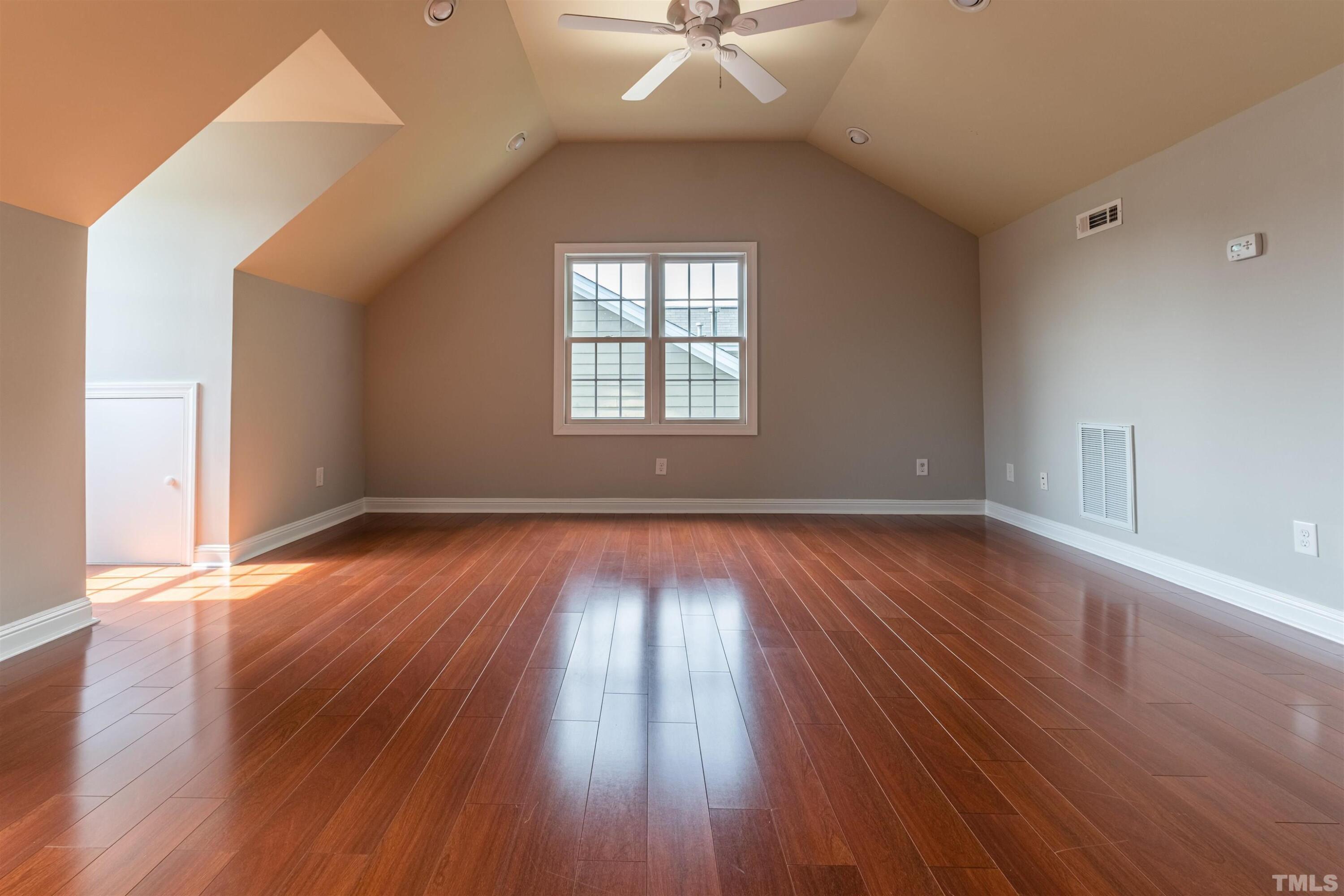 125 Old Grove Lane Apex, NC 27502 - Photo 23 of 30 an empty room with wooden floor and windows