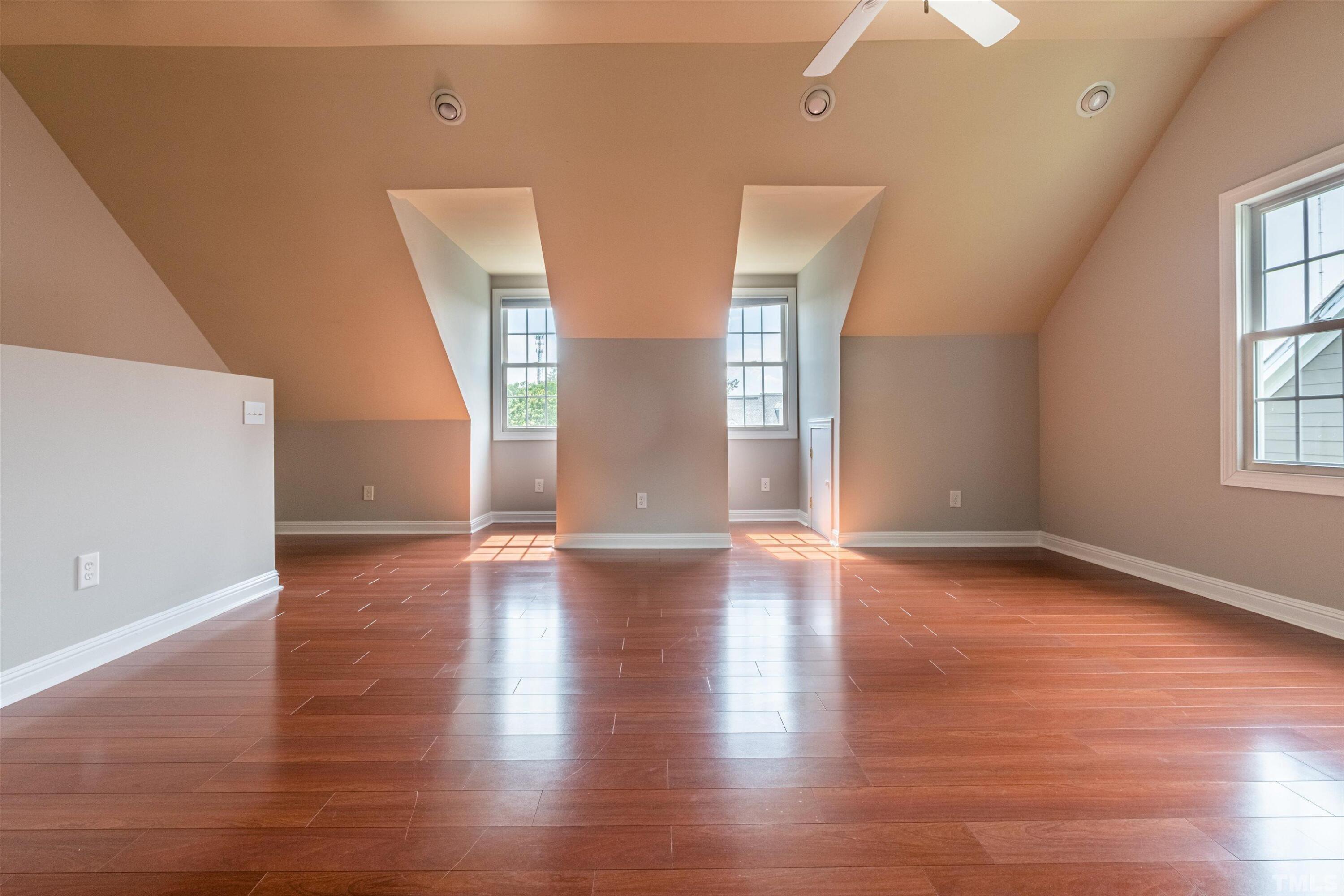 125 Old Grove Lane Apex, NC 27502 - Photo 24 of 30 an empty room with wooden floor and windows
