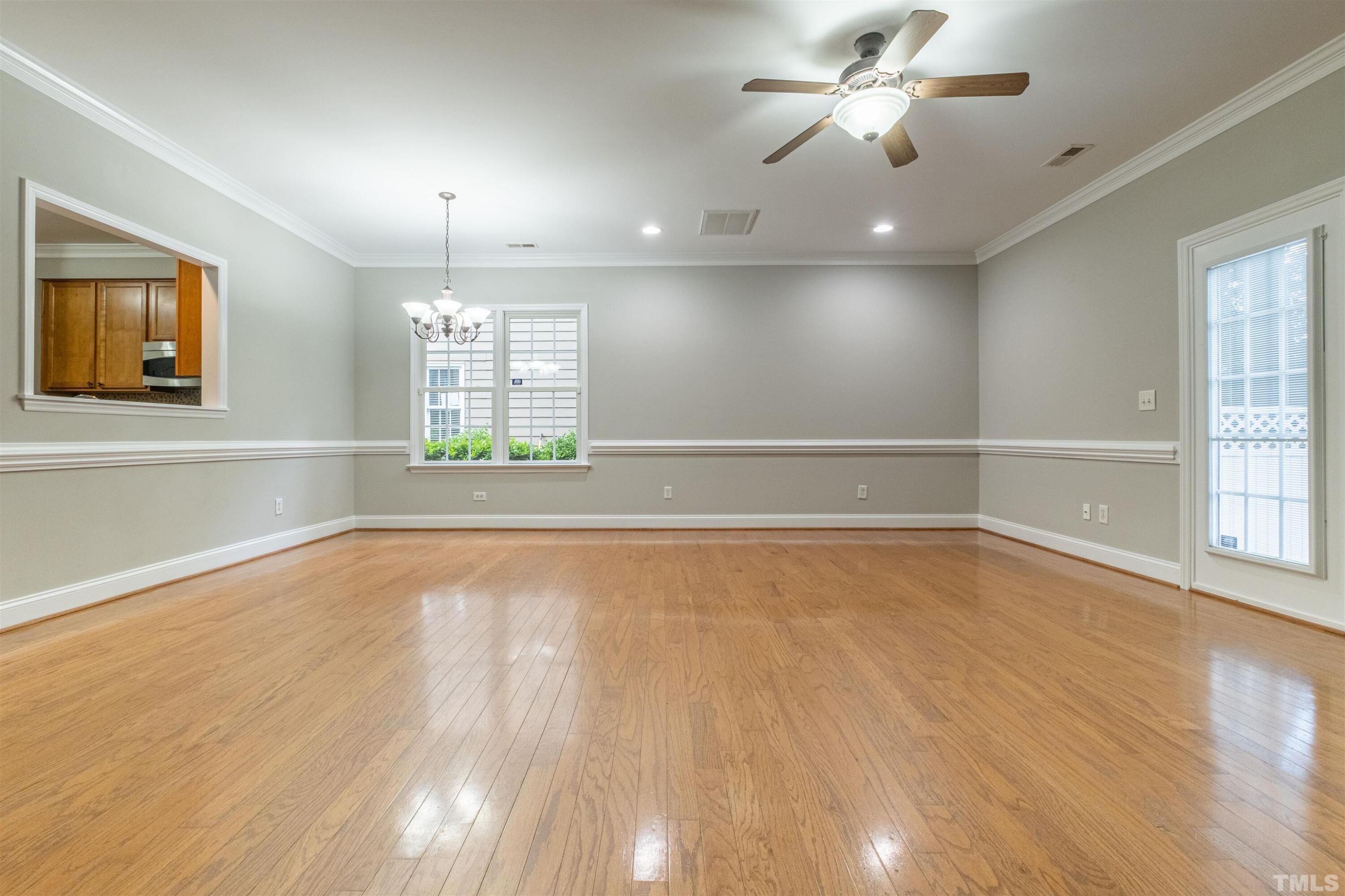 125 Old Grove Lane Apex, NC 27502 - Photo 3 of 30 a view of an empty room with wooden floor and a window