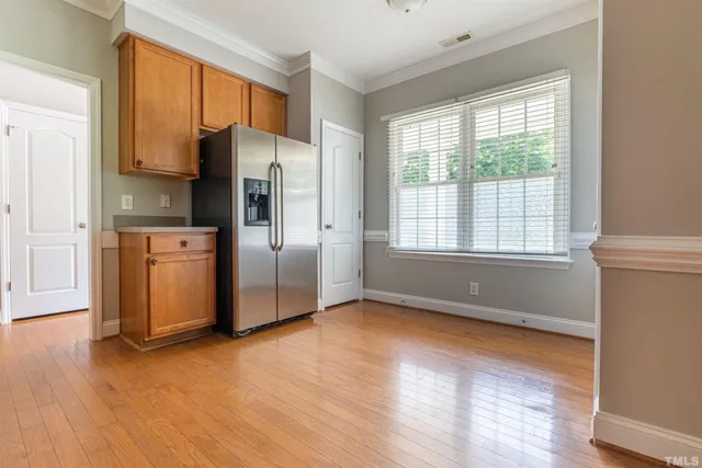 a kitchen with stainless steel appliances a refrigerator sink and microwave
