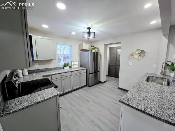 a kitchen with a sink stove and cabinets