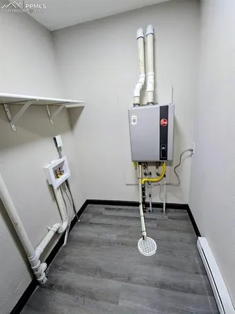 a room with gym equipment and wooden floor