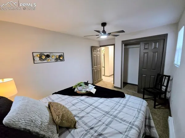 a bedroom with a bed and a chandelier