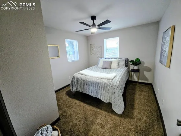 a bedroom with a bed and window