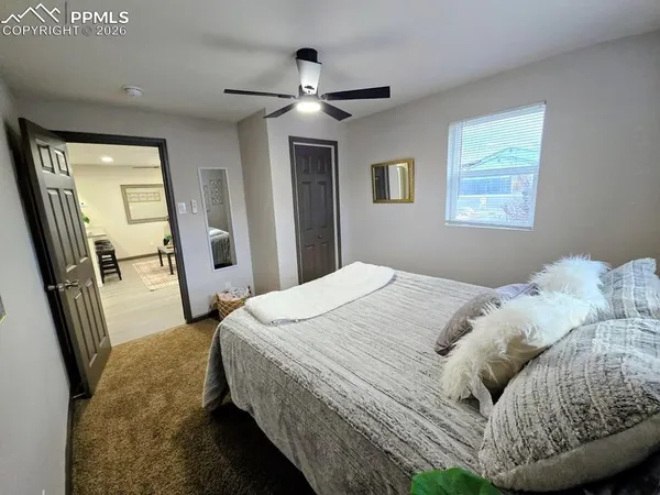 a bedroom with a bed and a mirror