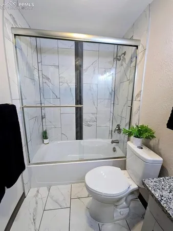 a bathroom with a toilet and a shower