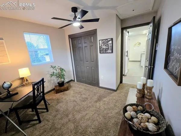 a living room with furniture and a potted plant