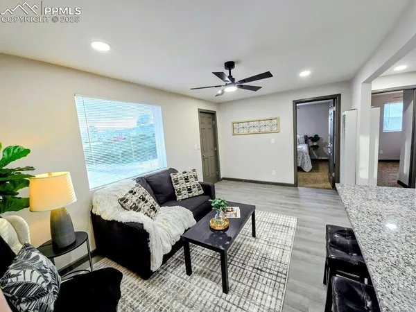 a living room with furniture and a large window