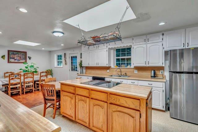 111 South Briaroaks Road Burleson, TX 76028 - Photo 18 of 39 a kitchen with stainless steel appliances granite countertop a stove refrigerator dining table and chairs