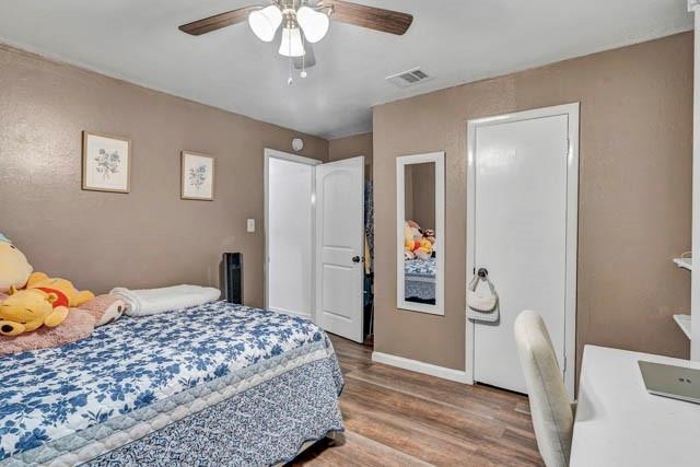 111 South Briaroaks Road Burleson, TX 76028 - Photo 25 of 39 a bedroom with a bed and a chandelier