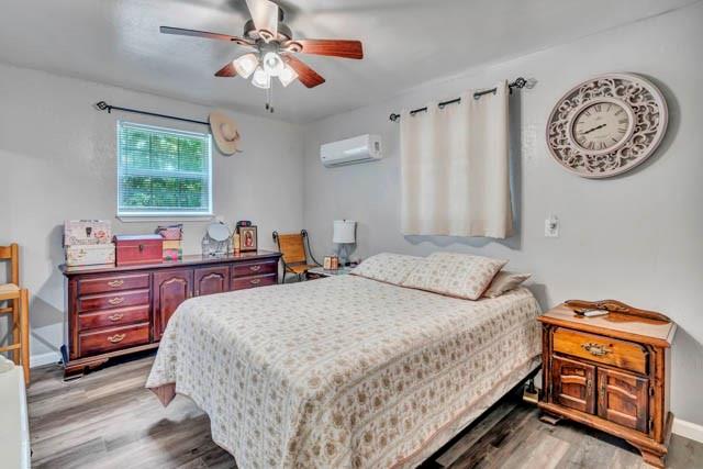 111 South Briaroaks Road Burleson, TX 76028 - Photo 26 of 39 a bedroom with a bed and a chandelier