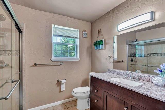 111 South Briaroaks Road Burleson, TX 76028 - Photo 32 of 39 a bathroom with a granite countertop toilet sink and mirror