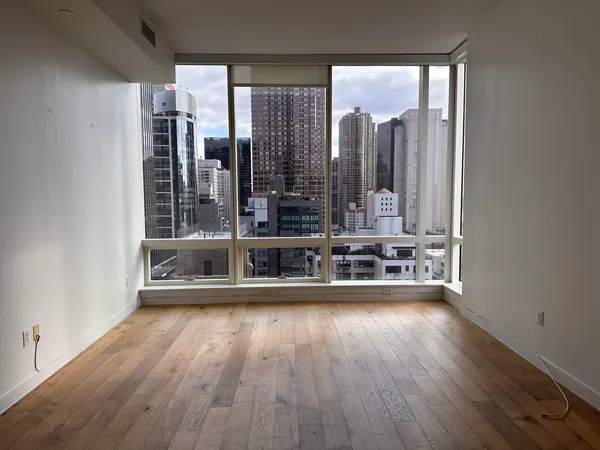 a view of a room with wooden floor